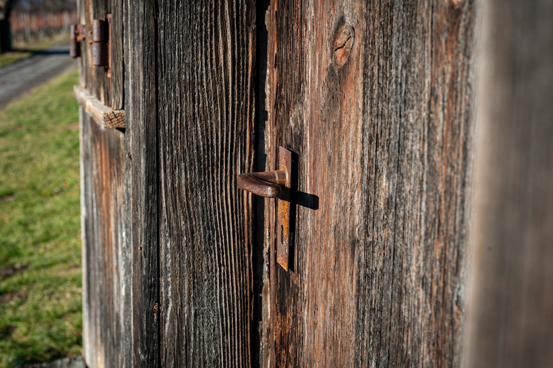 A close up of a wooden fence with a street in the background